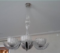 Glass chandelier installed flush over dinning room table on low ceiling apt. Upper west side. NYC.